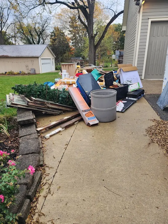 Dumpster being loaded with debris for 10 Yard Dumpster Rental in Orosi